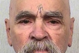 Charles Manson looks down the barrel of the camera for a mugshot photograph.