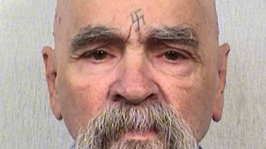 Charles Manson looks down the barrel of the camera for a mugshot photograph.