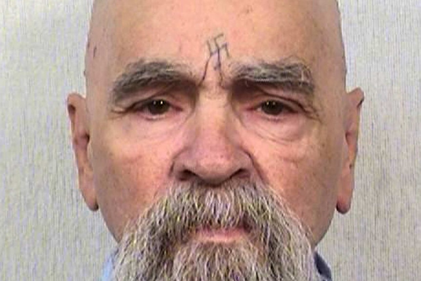 Charles Manson looks down the barrel of the camera for a mugshot photograph.