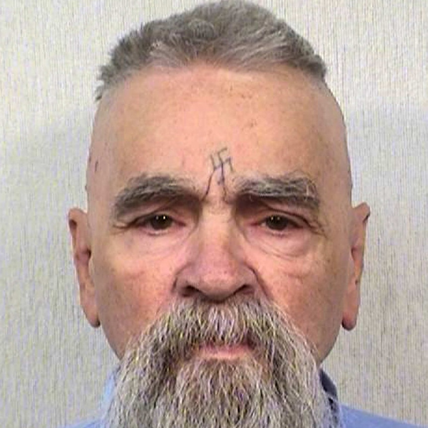 Charles Manson looks down the barrel of the camera for a mugshot photograph.