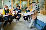 Boys playing hand-made guitars with luthier Peter Winskill