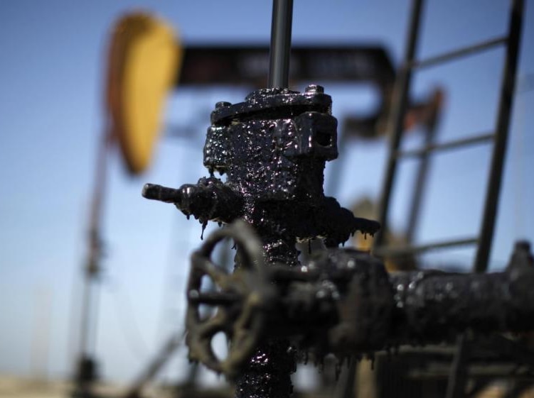 Pump taps cover with oil in the Midway Sunset oilfield, California