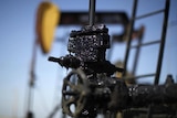 Pump taps cover with oil in the Midway Sunset oilfield, California