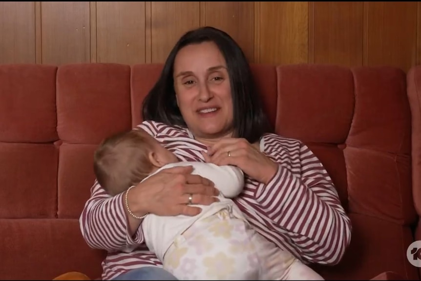 A woman holding a baby.