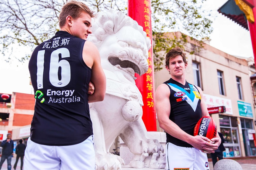 Port Adelaide players model jumpers for Multicultural Round