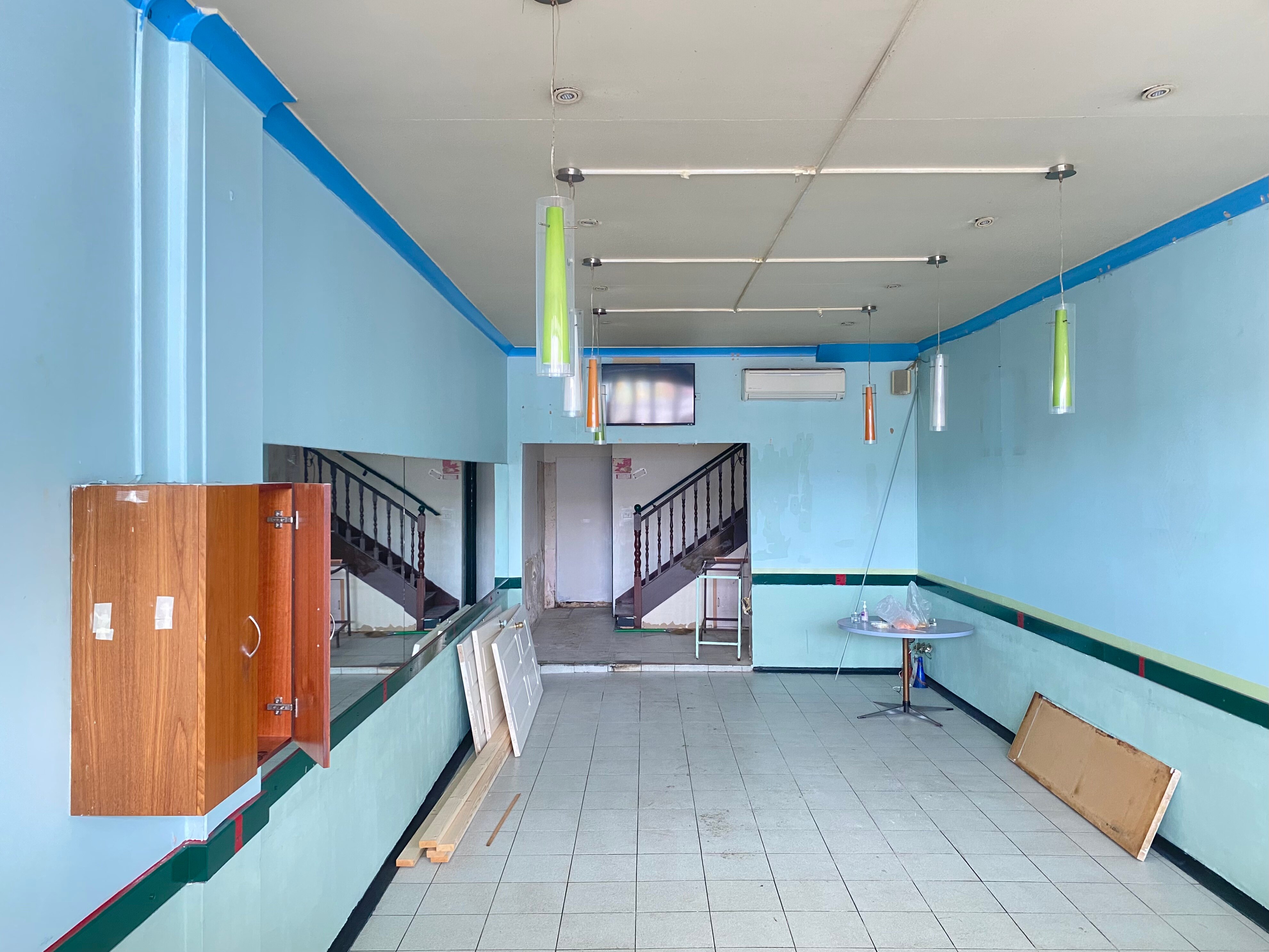 An empty storefront painted blue.