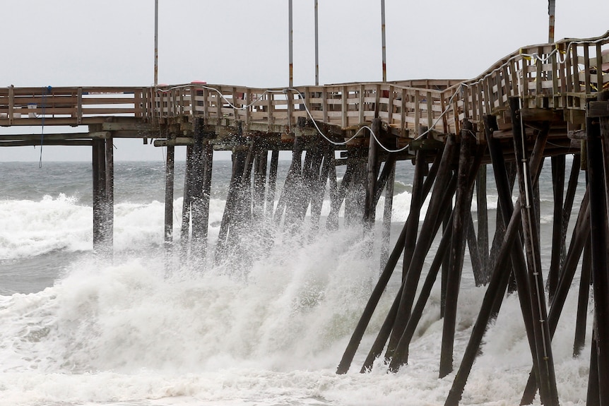 Waves hit the pier at Cape Hatteras National Seashore in Avon, North Carolina.