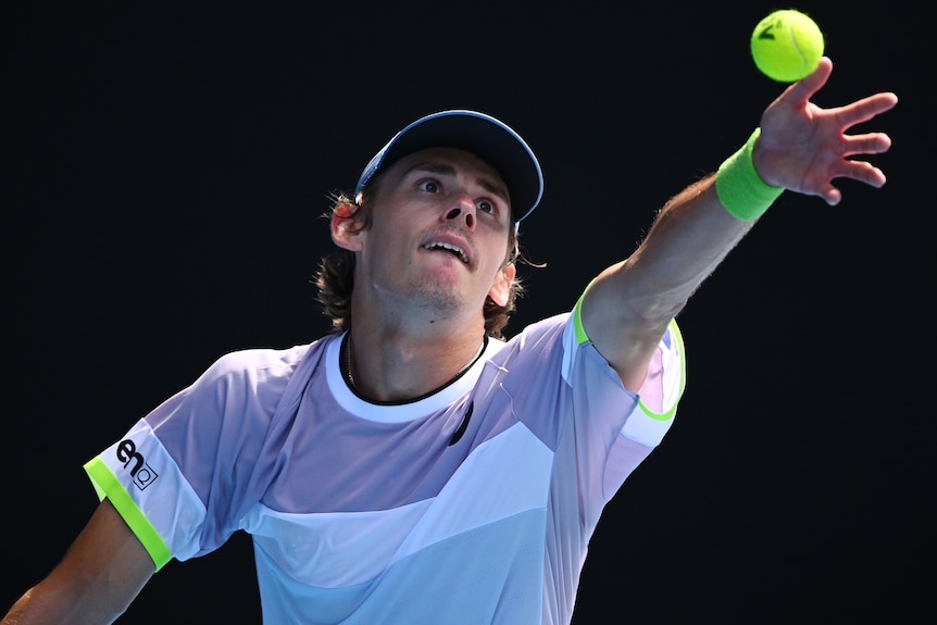 An Australian male prepares to serve at the Australian Open.