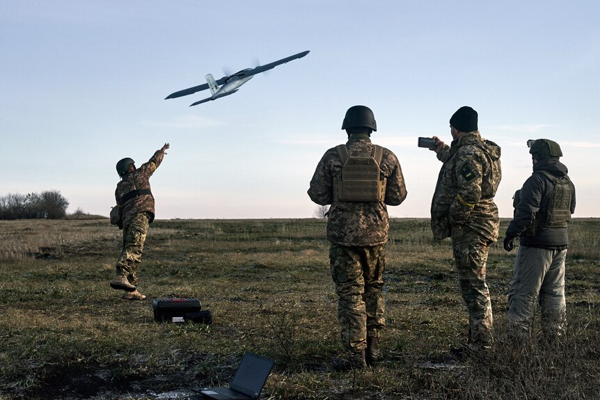 Ukrainian soldiers launch a drone at Russian positions near Bakhmut.