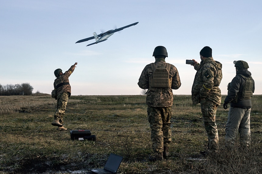 Ukrainian soldiers launch a drone.