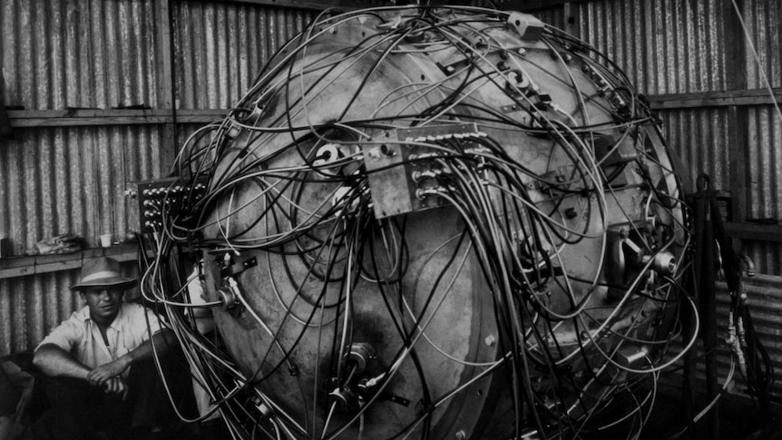 Physicist Norris Bradbury sits next to The Gadget the nuclear device created by scientists to test the world's first atomic bomb