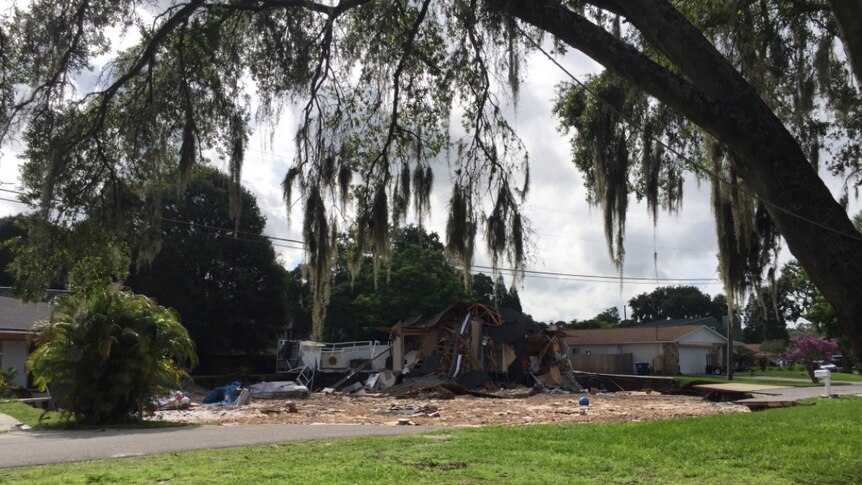 A sinkhole slowly swallows a house in Florida.