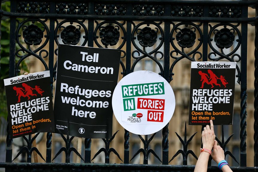 Placards are attached to the railings of the UK's Houses of Parliament