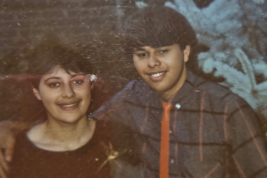 Andrew and Margaret Gardiner smile as they pose for a photograph together, as teenagers or young adults.