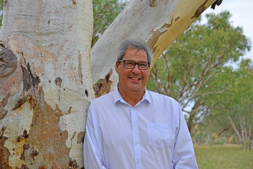 A man smiles at a camera