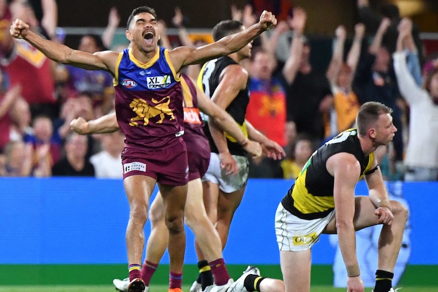 Charlie Cameron screams with his arms outstretched as Dylan Grimes looks sad on one knee