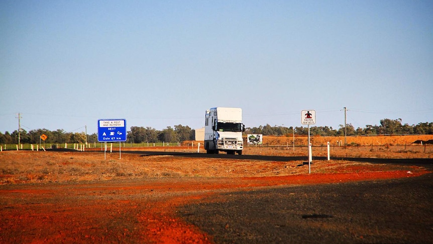 The truck of Sydney dentist Dr Jalal Khan, with a mobile dental surgery onboard, driving on a road in outback Queensland.