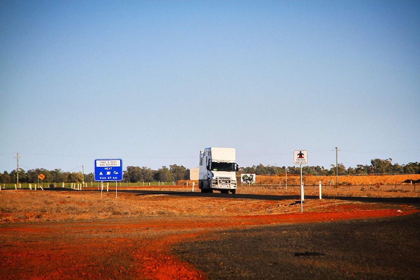 The truck of Sydney dentist Dr Jalal Khan, with a mobile dental surgery onboard, driving on a road in outback Queensland.