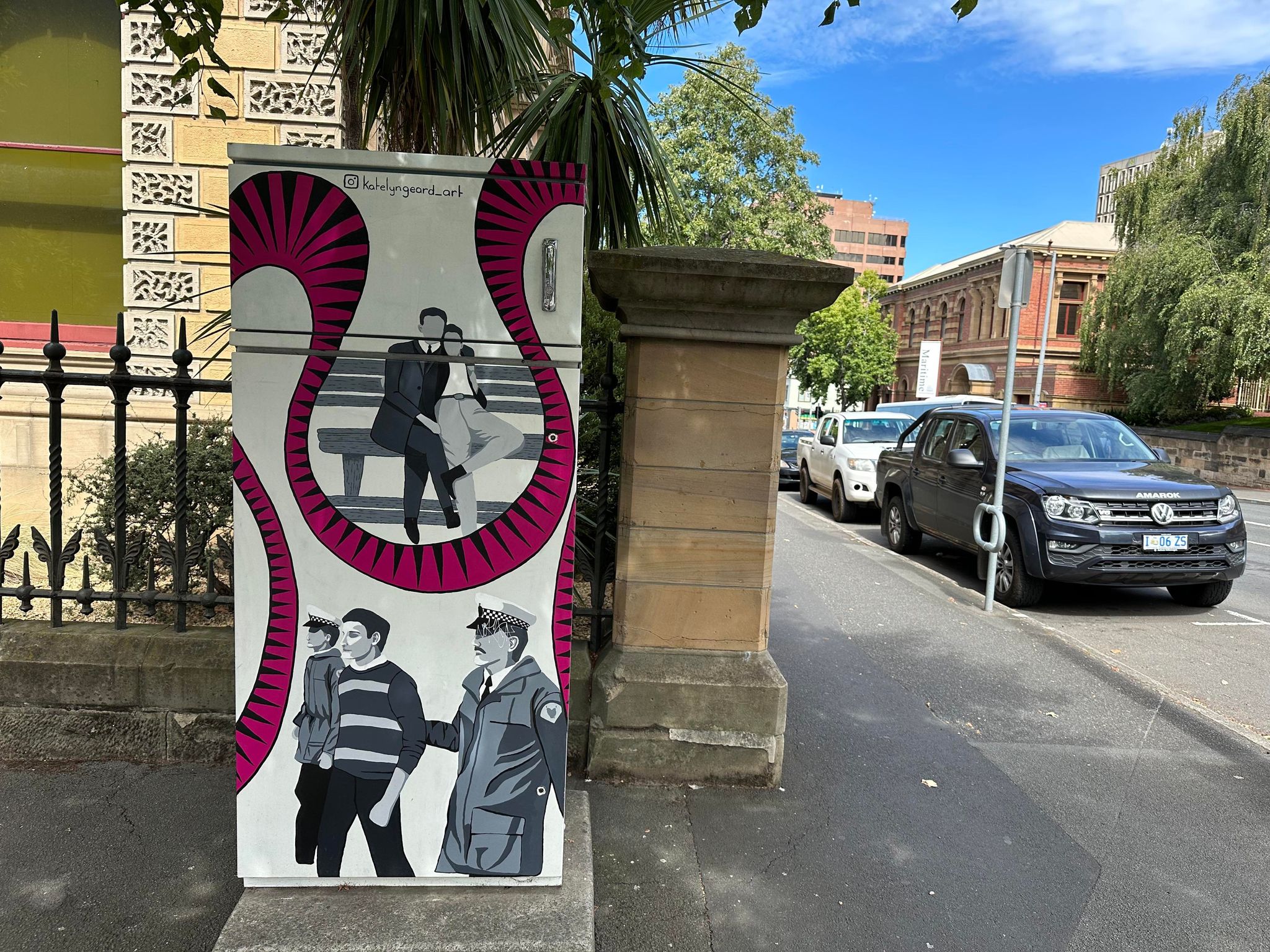 Power box painting with a picture of a gay couple and a man getting arrested 