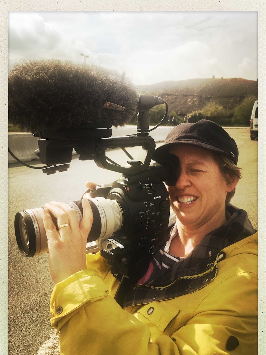Poppy Stockell with camera filming.