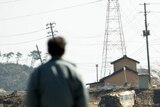 Looking back ... a man looks across tsunami devastation in Minamisoma city.