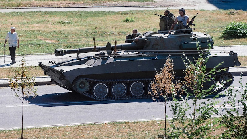 Tank carrying pro-Russian rebels into Donetsk in Ukraine