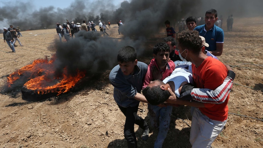 A wounded Palestinian demonstrator is evacuated during a protest