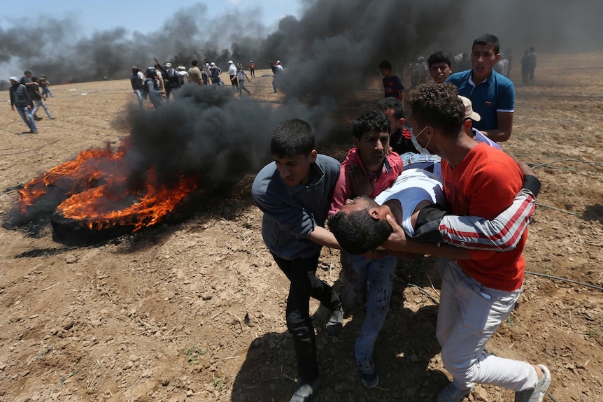A wounded Palestinian demonstrator is evacuated during a protest