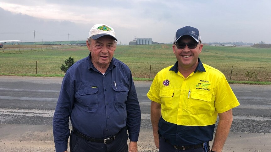 Ron and Michael Perich standing by the roadside looking over their dairy property at Leppington in Sydney.