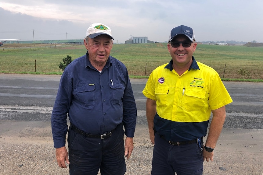 Ron and Michael Perich standing by the roadside looking over their dairy property at Leppington in Sydney.