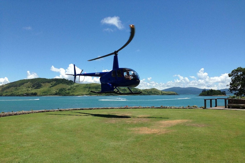 A helicopter lands at The Qualia helipad on Hamilton Island.