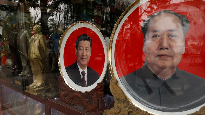 Xi Jinping and Mao Zedong appear on plates for sale in a store window.