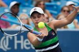 Ash Barty concentrates to return a serve on the forehand.