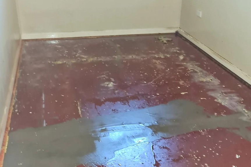 Damage to funeral home floor shown, from water and floods. 