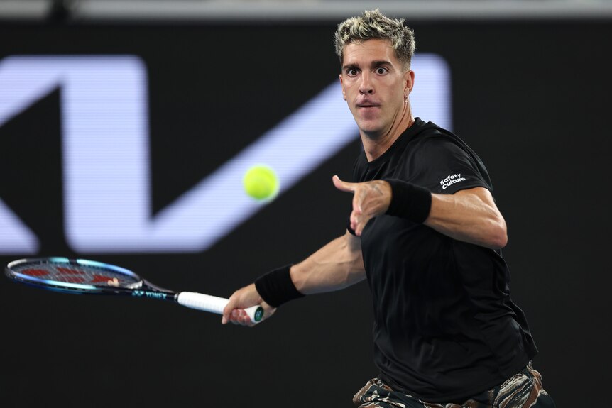 An Australian male tennis player prepares to hit a forehand at the Australian Open.