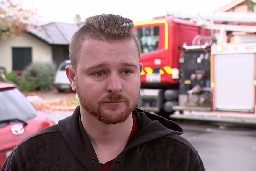 Ben Murphy speaks to the media in front of a house which caught alight at Ferryden Park, Adelaide