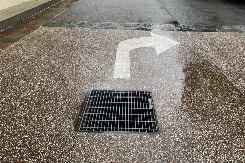 A cover over a stormwater drain in an apartment complex driveway