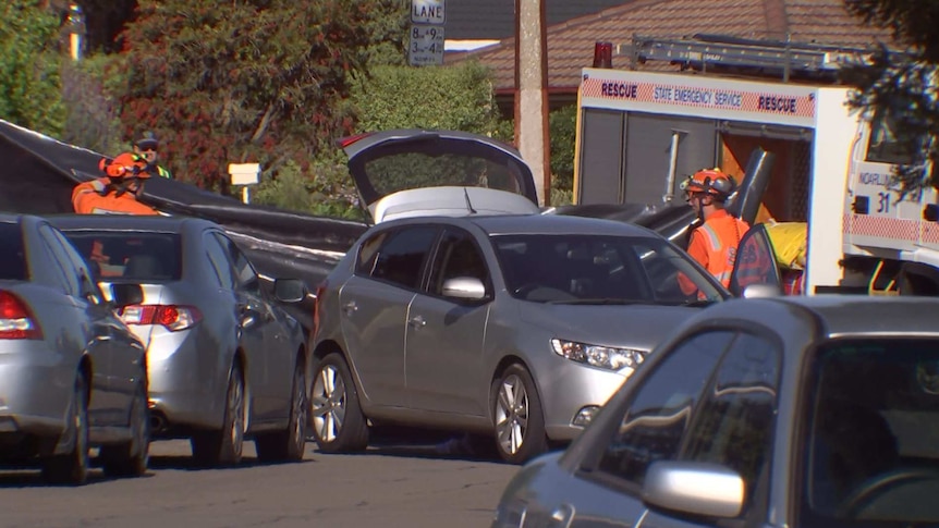A hatchback with its booten open next to an SES vehicle