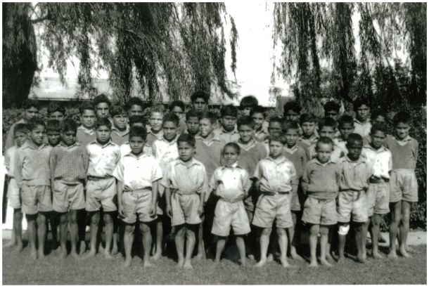 Black and white photo of boys at Kinchela Boys Home with no shoes on