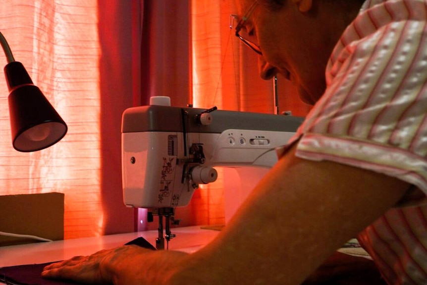 A woman sewing.