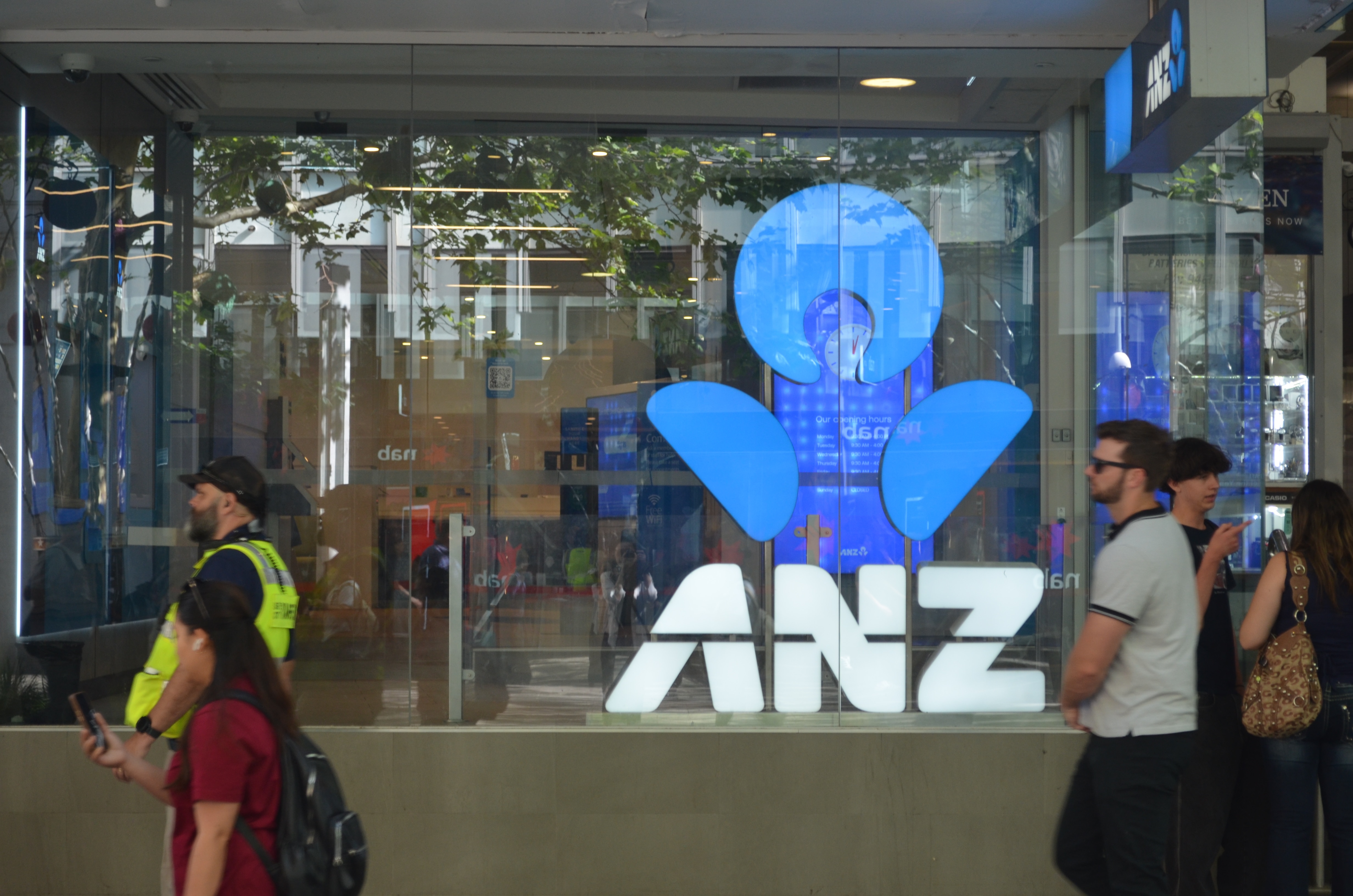 People walk past an ANZ bank in Perth's city centre. 