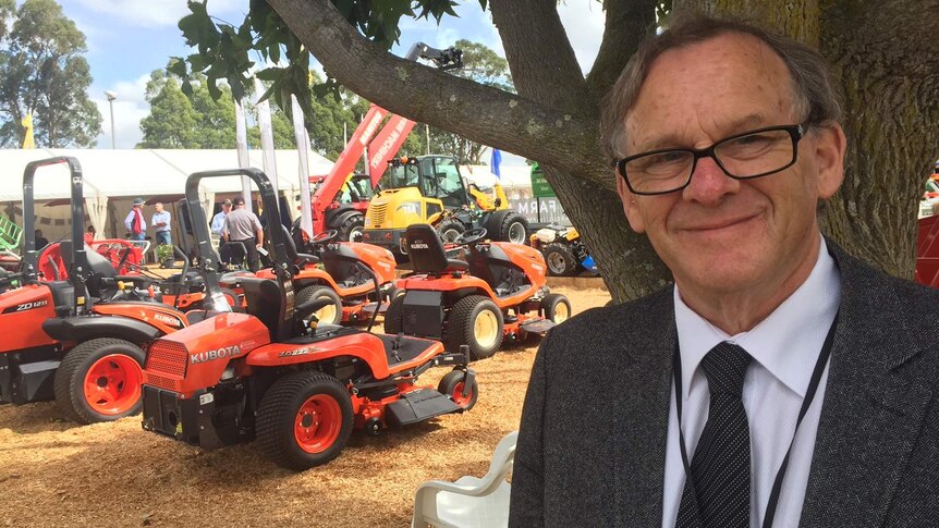 Graham Rowe standing in front of his farm machinery display at Farm World.