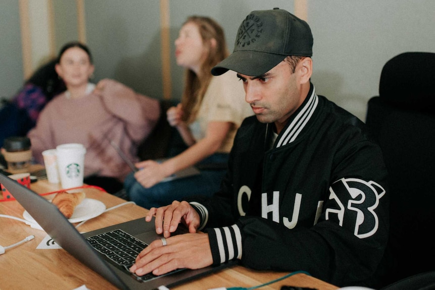 Tushar Apte sits in front of a laptop