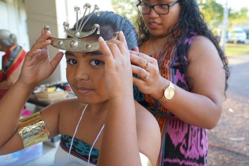 A girl prepares for traditional Timor-Leste dancing at a mass in Darwin.