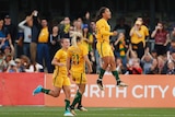 Australia's Sam Kerr (R) celebrates after scoring a goal against Brazil in Penrith.