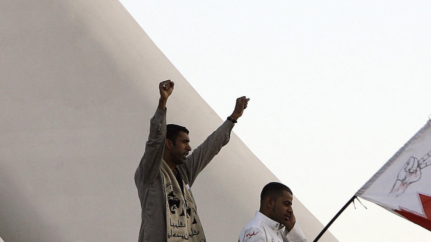 Anti-government protesters stand on the Pearl Monument