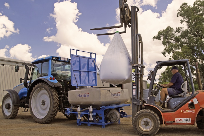 Loading fertiliser onto tractor