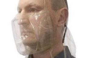 A man wearing a clear plastic spit hood