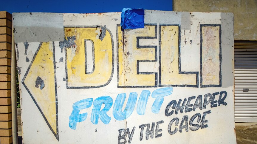 Faded signwriting on a closed deli and fruit vendor on a neighbourhood street corner in East Victoria Park