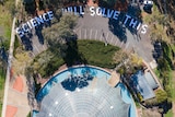 Aerial image of the shine dome with the words Science Will Solve This written in the car park.